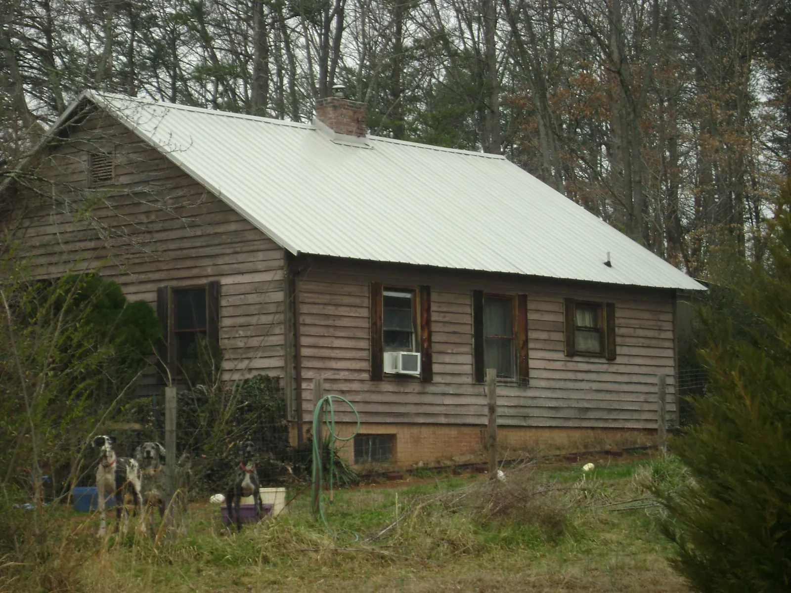 White metal roof on an old wood sided farmhouse, from a Metal Roof Installation job in Southbridge